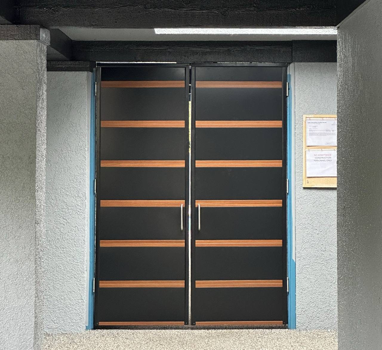 Custom black-and-wood metal entry doors